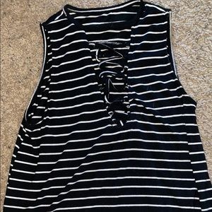 Black and white sleeveless shirt. Open cleavage